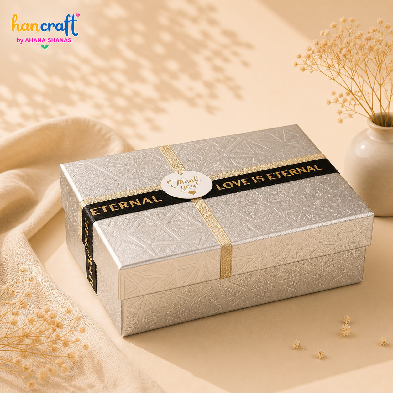 aesthetic-silver-embossed-rectangular-gift-box.webp Premium silver embossed gift box with black and gold ribbon design